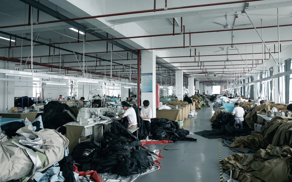 Large-scale tent manufacturing workshop with organized production environment