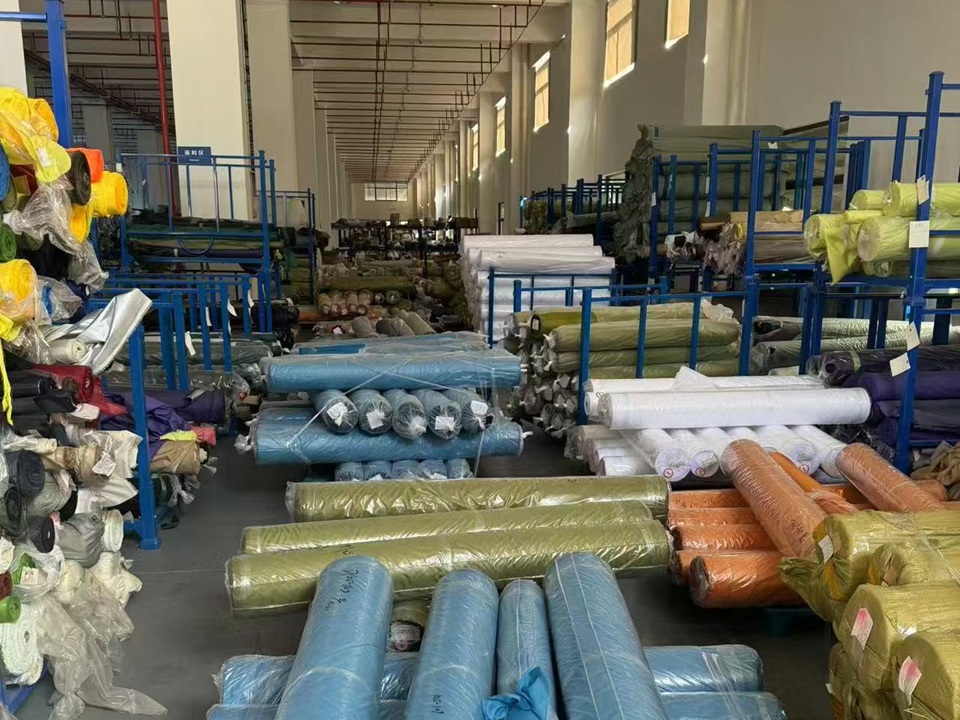 Tent fabric rolls and raw materials stored in NastoCamp warehouse before production