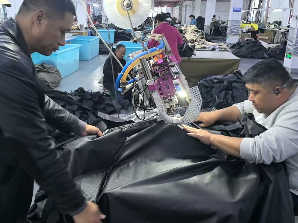 Applying custom customer logo through heat transfer process during OEM tent production at NastoCamp