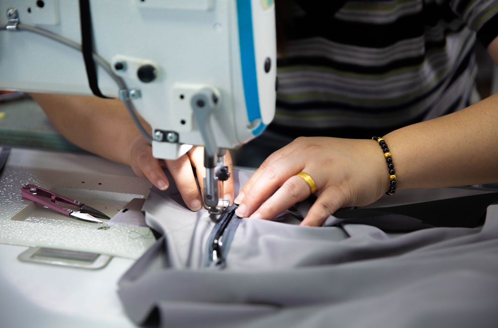Experienced workers sewing camping tents in NastoCamp manufacturing facility