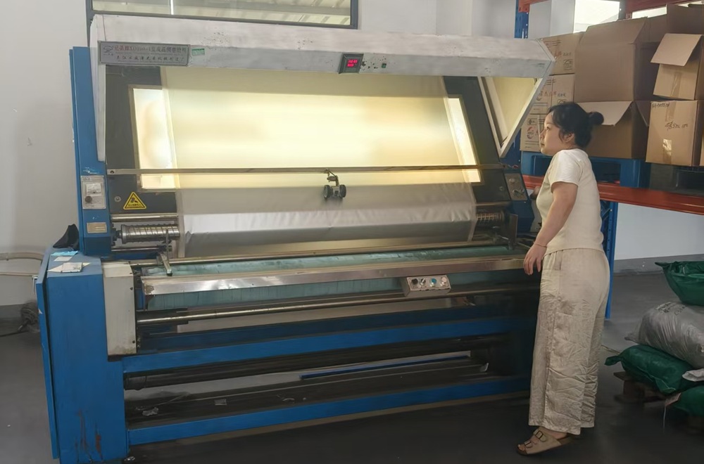 Fabric inspection machine checking tent materials before OEM camping tent production