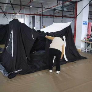 Quality inspector checking tent assembly before shipment