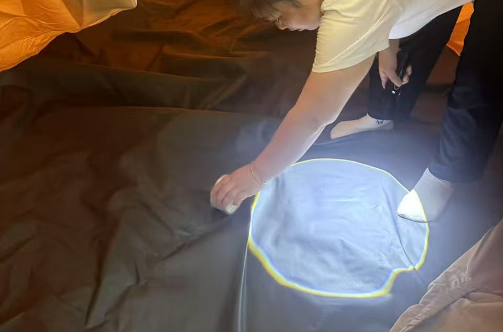 Quality inspector checking tent interior during rain testing