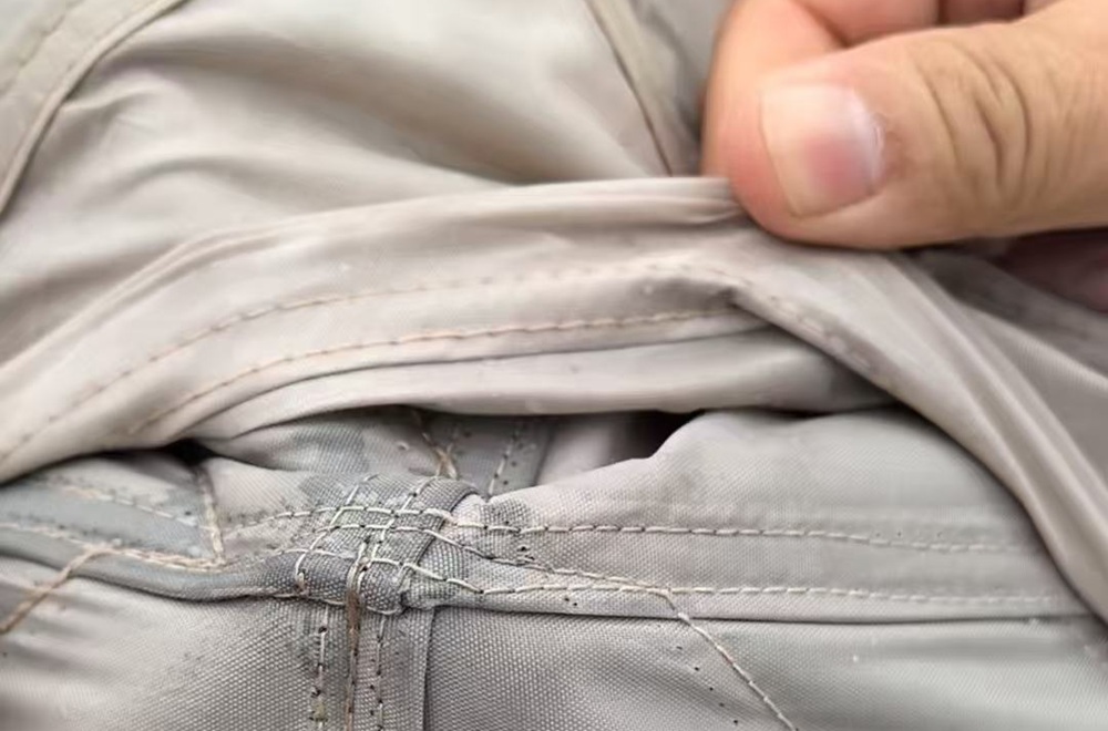 Close-up of waterproof seam construction on an OEM camping tent