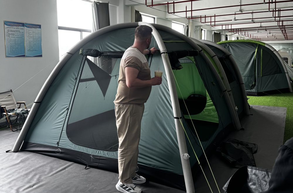 Outdoor brand reviewing a custom inflatable tent prototype at NastoCamp OEM tent factory