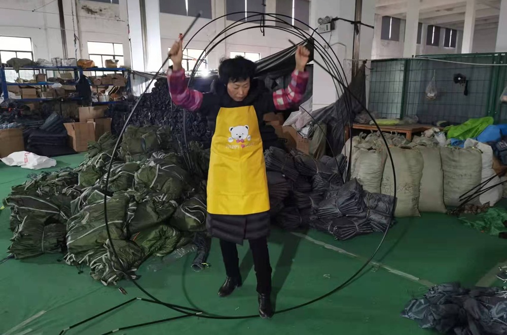 Fiberglass tent pole demonstrating flexibility during OEM inspection