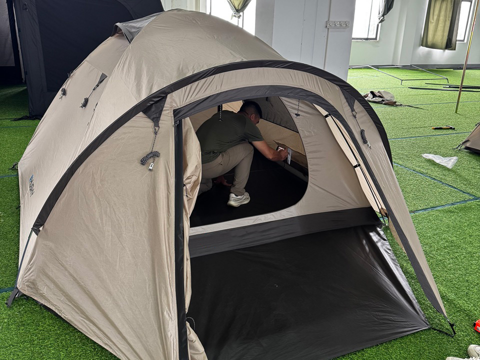 Czech customer inspecting a camping tent during a factory visit and product evaluation at NastoCamp.