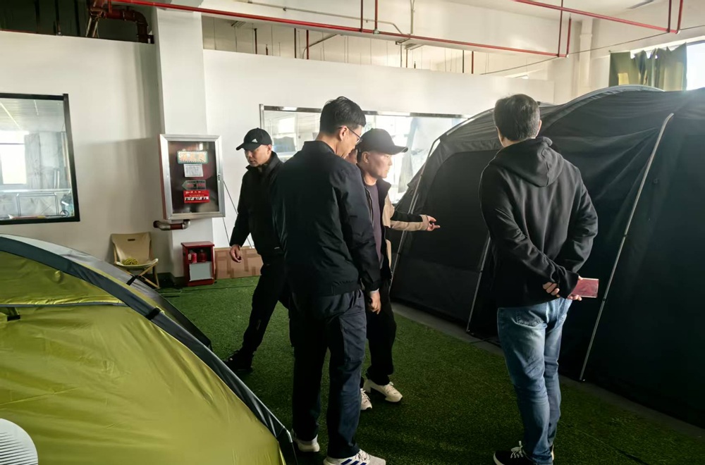 Outdoor brand representatives discussing custom tent development with NastoCamp OEM engineers