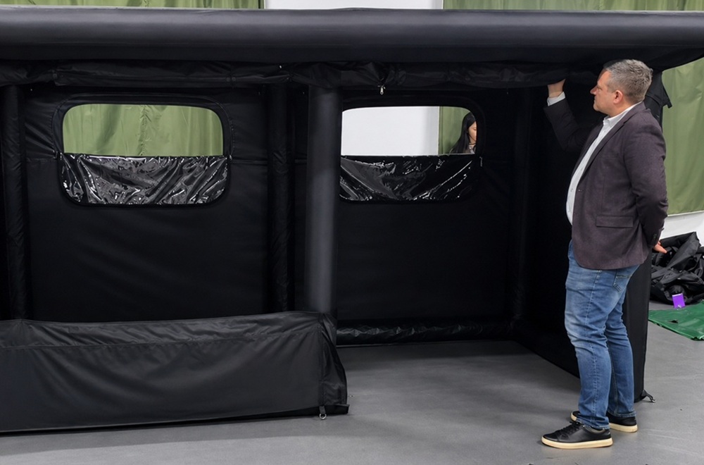 Outdoor brand representative evaluating a custom tent with an OEM manufacturer during product discussion