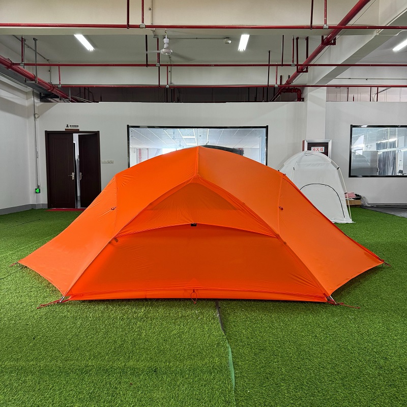 Rear view of two-person trekking tent showing flysheet ventilation structure