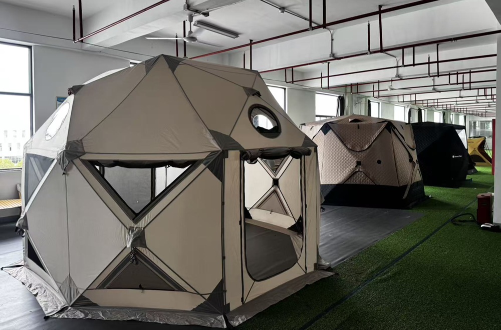 Large and complex camping tents displayed inside an OEM tent manufacturing facility for product development
