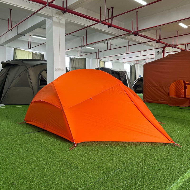 Lightweight two-person hiking tent showing extended vestibule and low-profile dome structure
