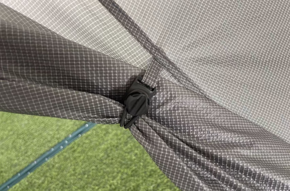 Lightweight ripstop tent fabric with reinforced seam and hardware connection