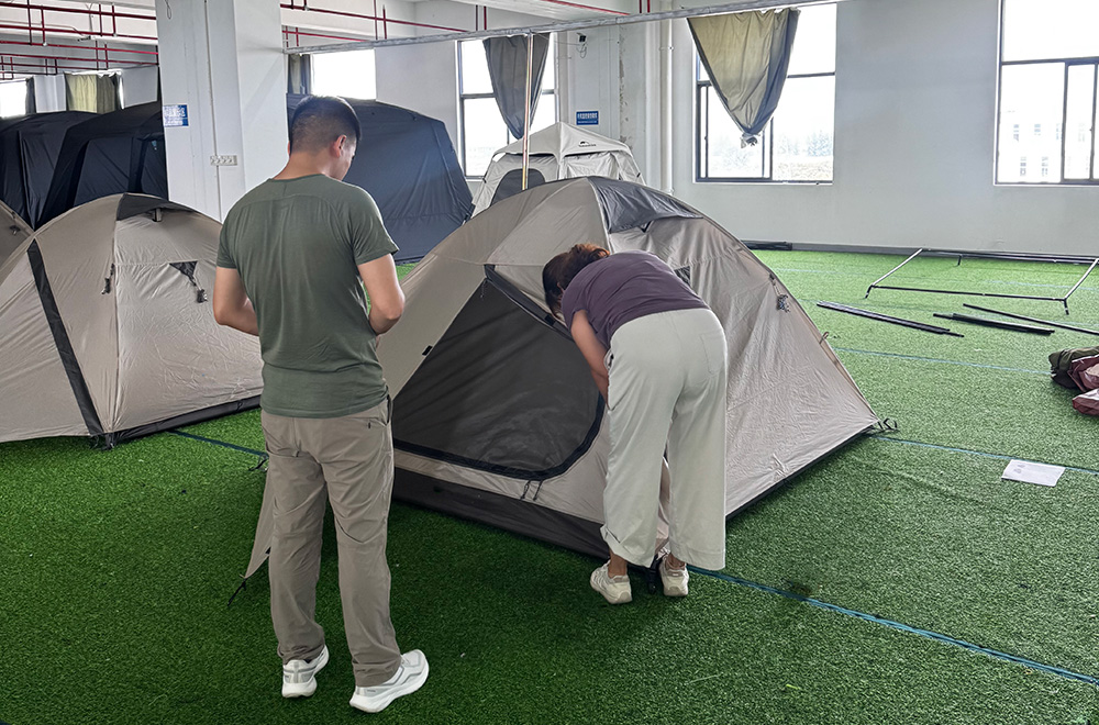 Outdoor brand representative reviewing a custom tent sample during OEM product development