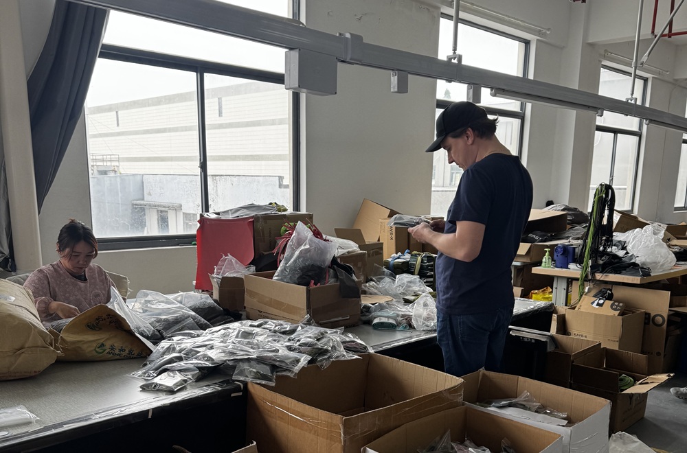 Workers preparing camping tent products inside an OEM tent manufacturing facility