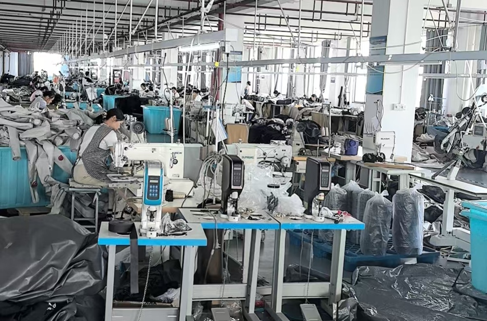 Tent manufacturing workshop with sewing workers producing outdoor tents in an OEM factory