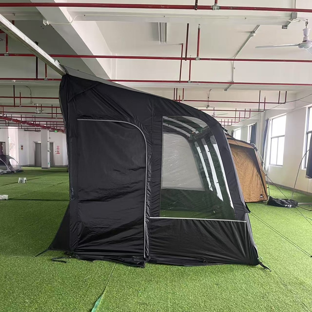Vehicle-side inflatable awning end panel with door and clear window