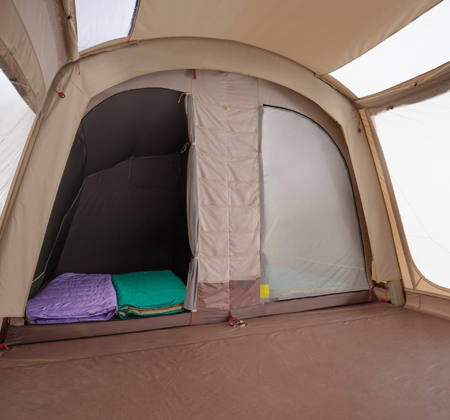 Interior of inflatable family tent showing bedroom and spacious living area