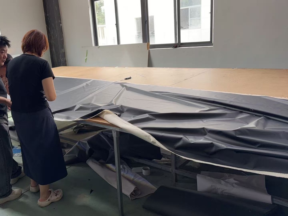NastoCamp team and fabric supplier inspecting defects found during incoming tent fabric quality control.
