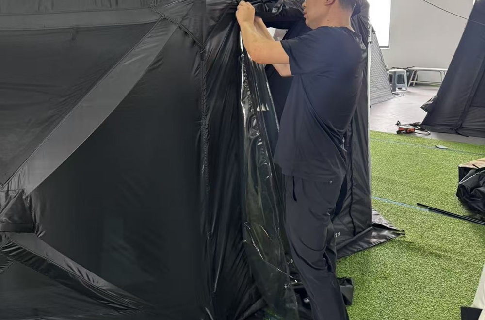 Tent zipper being inspected on a sample tent at NastoCamp
