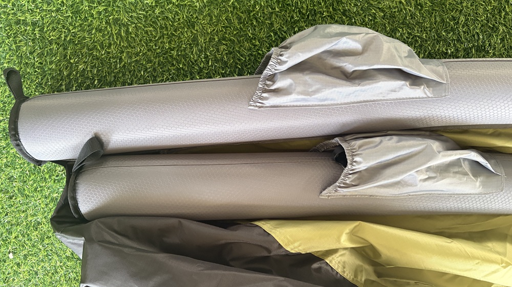 Close-up of inflatable tent air beams showing fabric sleeves and connection details