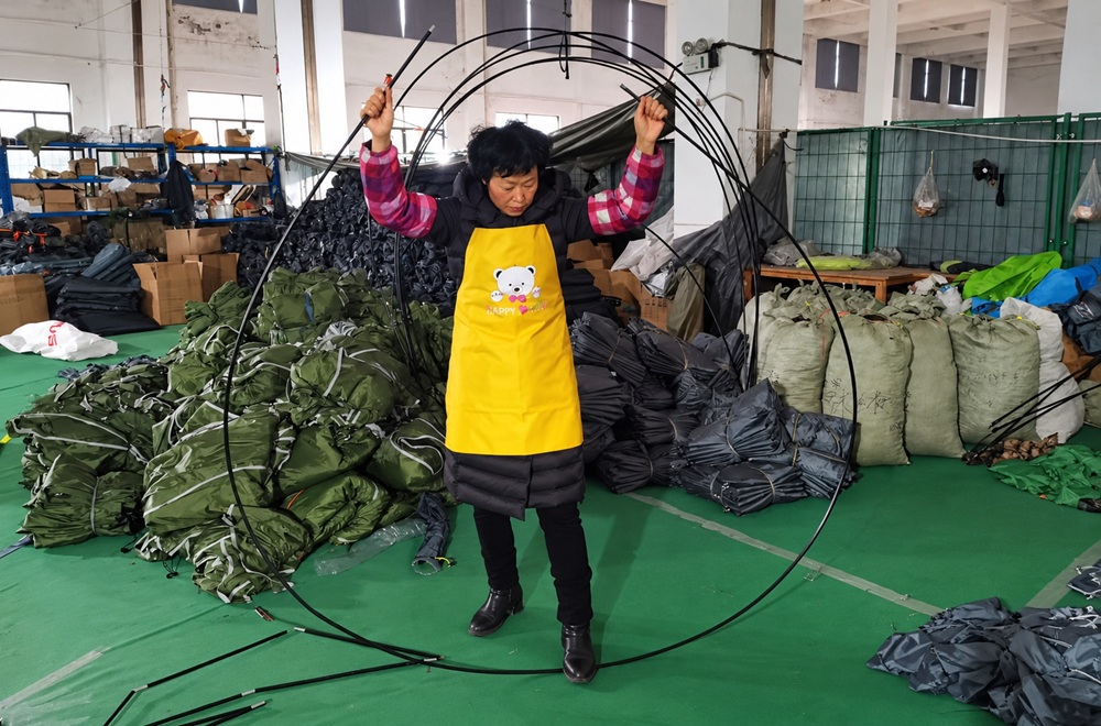 Tent poles being handled during OEM tent production at NastoCamp