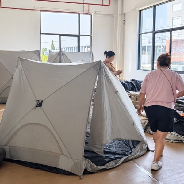 NastoCamp team inspecting finished tents during quality control at the factory