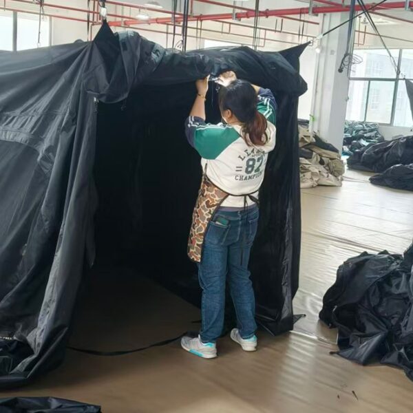 Tent Quality Control Inspection at NastoCamp NastoCamp quality control staff inspecting a tent during production