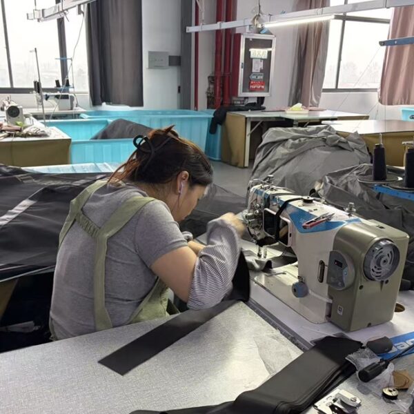 Worker sewing tent fabric at the NastoCamp manufacturing facility