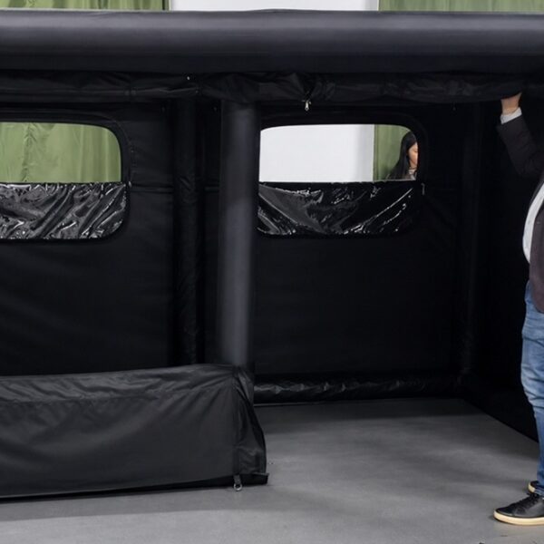 Outdoor Brand Discussing Custom Tent Development With OEM Manufacturer Outdoor brand representative evaluating a custom tent with an OEM manufacturer during product discussion
