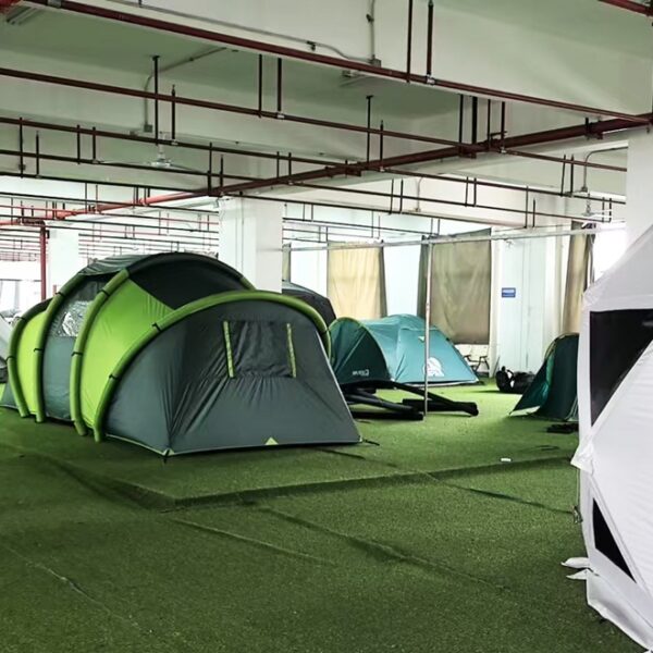 Different camping tent structures including dome, tunnel, inflatable, and geodesic tents displayed in the NastoCamp OEM showroom.